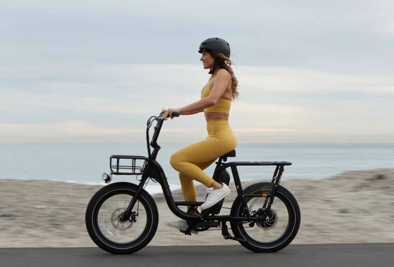 Rad Power RadRunner 2 electric bike ridden by a woman in a yellow outfit
